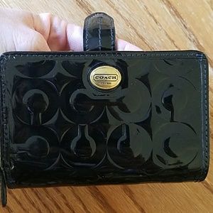 Patent leather coach wallet.